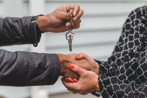 person handing over house keys