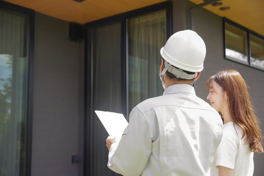 an inspector and a house owner examining a property