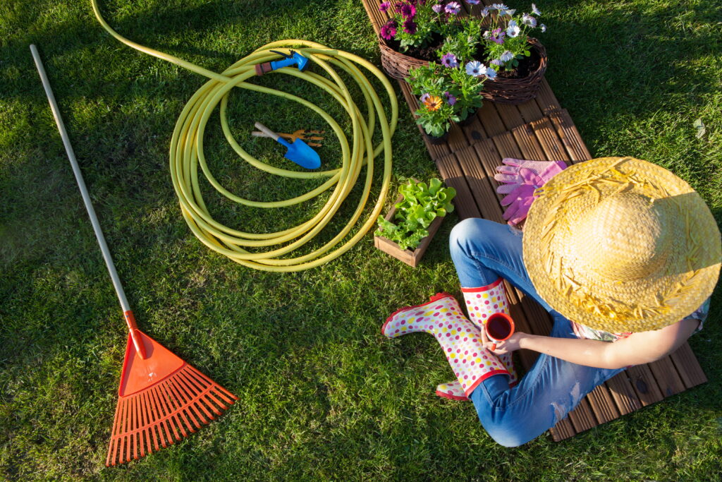 Woman having a coffee break while working in the garden